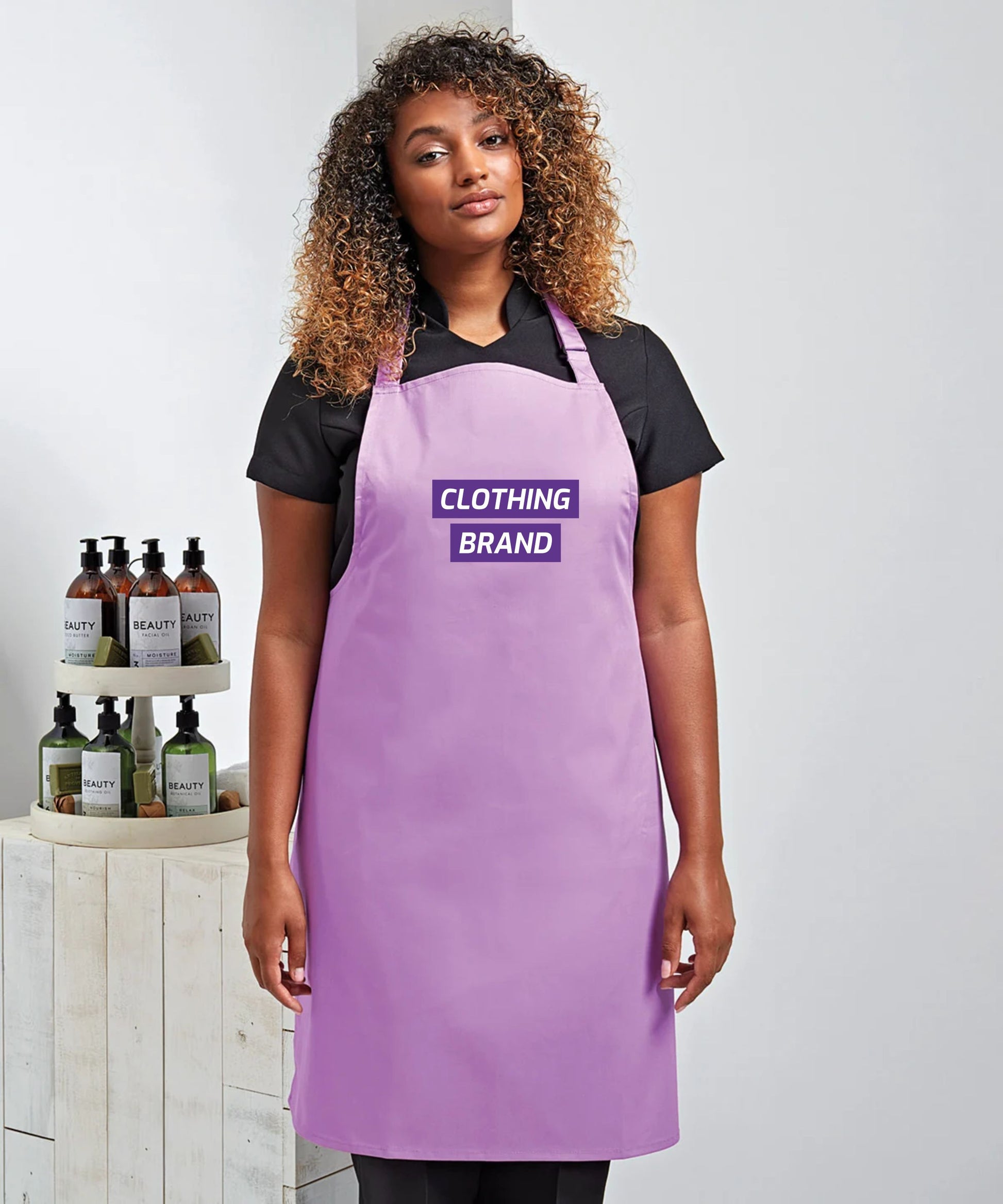 A vibrant Premier Colours Bib Apron with a custom printed logo, displayed on a mannequin—ideal for hospitality staff uniforms.
