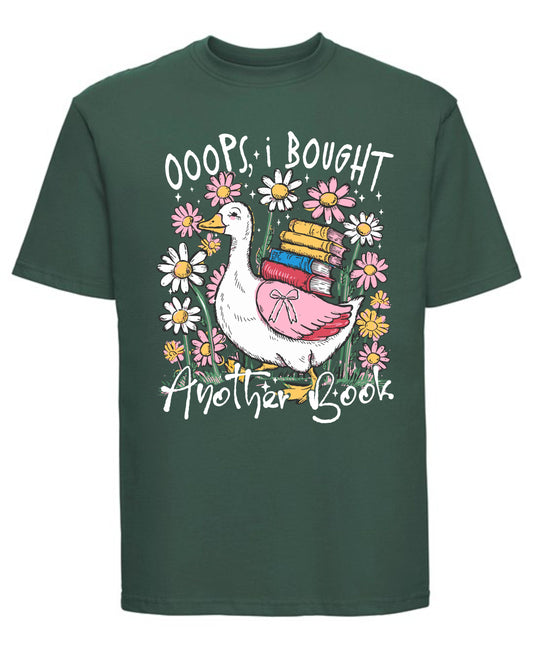 Green t-shirt with a graphic of a duck holding books and flowers, with text 'OOPS I BOUGHT ANOTHER BOOK'.